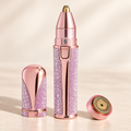 Pink electric eyebrow trimmer with precision head exposed, matching cap and round facial head.